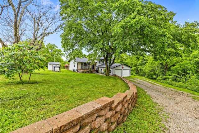 1650 Clouse Rd, Macomb, MO 65702 - view of front of home with an outbuilding, driveway, and a front lawn