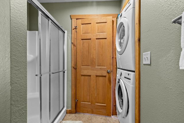 60 Mayberry Cir, Branson West, MO 65737 - laundry area with estacked washer and dryer, a textured wall, light tile patterned floors, and cabinet space