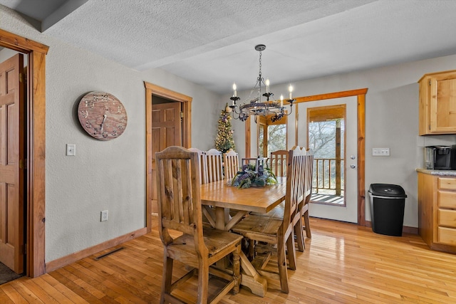 60 Mayberry Cir, Branson West, MO 65737 - dining room with baseboards, a chandelier, light wood-type flooring, a textured wall, and a textured ceiling