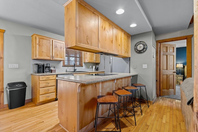 60 Mayberry Cir, Branson West, MO 65737 - kitchen featuring light wood finished floors, black electric cooktop, a sink, a kitchen breakfast bar, and recessed lighting