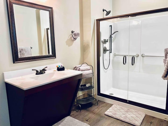 240 Chateau Cove Dr, Branson, MO 65616 - bathroom featuring a shower stall, wood finished floors, and vanity