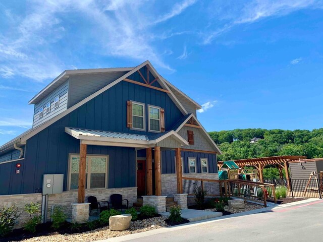 240 Chateau Cove Dr, Branson, MO 65616 - view of front of property featuring board and batten siding, stone siding, and a playground
