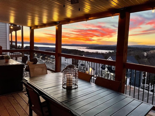 240 Chateau Cove Dr, Branson, MO 65616 - deck at dusk featuring a water view and outdoor dining area
