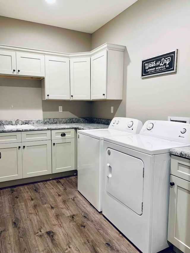 240 Chateau Cove Dr, Branson, MO 65616 - laundry room with cabinet space, washer and clothes dryer, and dark wood-type flooring