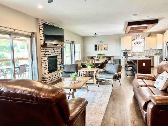 240 Chateau Cove Dr, Branson, MO 65616 - living room with wood finished floors and a stone fireplace