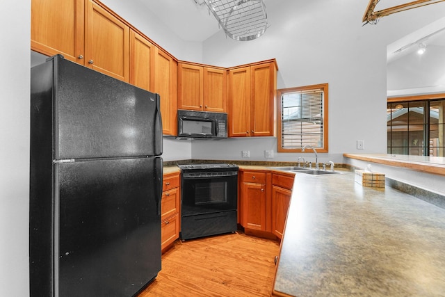 160 Village Trl, Indian Point, MO 65616 - kitchen with black appliances, a sink, light wood-style floors, and brown cabinetry