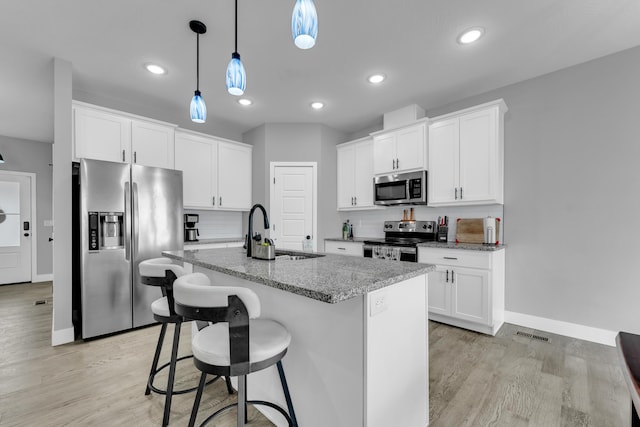 1682 Vicksburg Psge, Republic, MO 65738 - kitchen with appliances with stainless steel finishes, a sink, baseboards, tasteful backsplash, and light wood-style flooring
