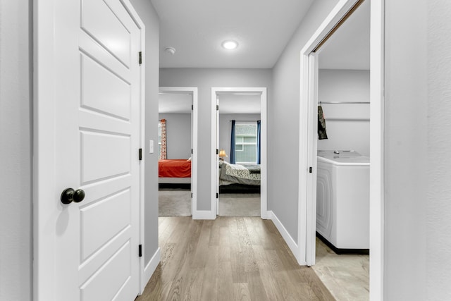1682 Vicksburg Psge, Republic, MO 65738 - hallway featuring washer / clothes dryer, light wood-style flooring, and baseboards
