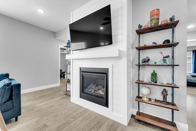 1682 Vicksburg Psge, Republic, MO 65738 - living room with a large fireplace, wood finished floors, baseboards, and recessed lighting