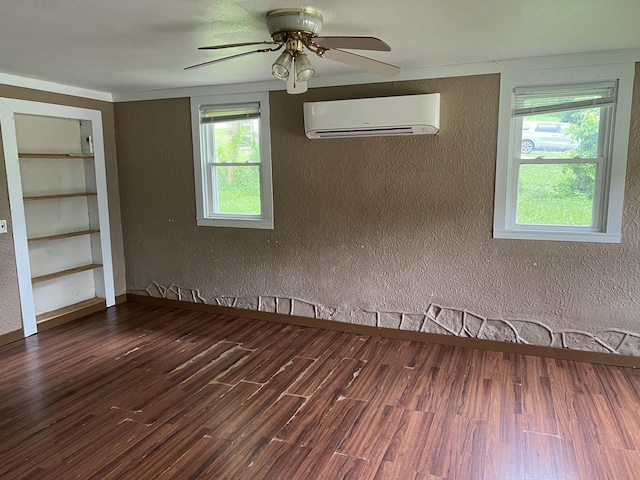 604 E Jordan St, Mansfield, MO 65704 - unfurnished room featuring an AC wall unit, a textured wall, ceiling fan, and wood finished floors
