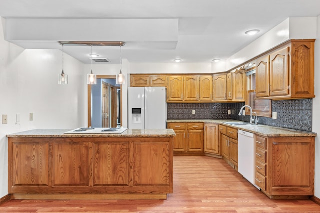 1007 Bryce Ln, Nixa, MO 65714 - kitchen with white appliances, a sink, a peninsula, and light wood finished floors