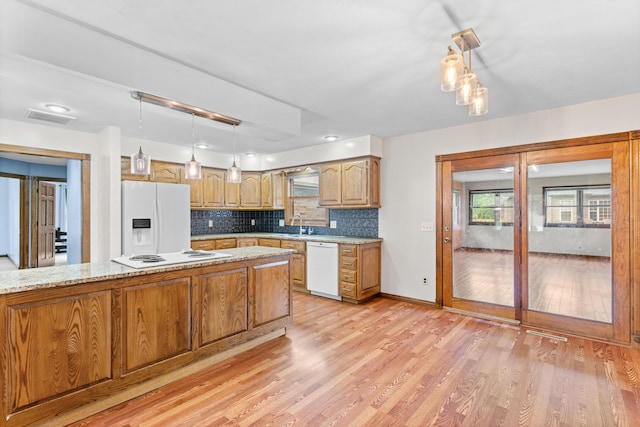 1007 Bryce Ln, Nixa, MO 65714 - kitchen featuring white appliances, light wood finished floors, decorative backsplash, and pendant lighting