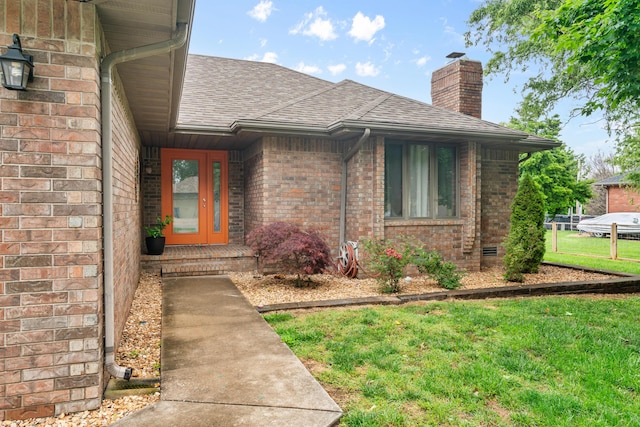 1007 Bryce Ln, Nixa, MO 65714 - property entrance featuring a shingled roof, a chimney, brick siding, and a lawn
