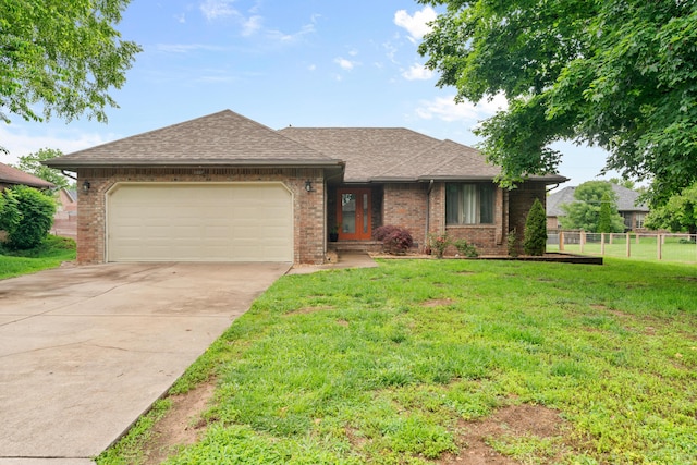 1007 Bryce Ln, Nixa, MO 65714 - view of front of house featuring an attached garage, concrete driveway, roof with shingles, and brick siding