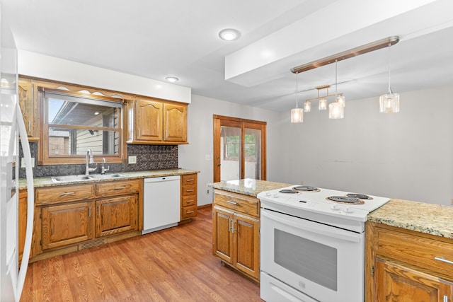 1007 Bryce Ln, Nixa, MO 65714 - kitchen with white appliances, a sink, light wood finished floors, brown cabinetry, and pendant lighting