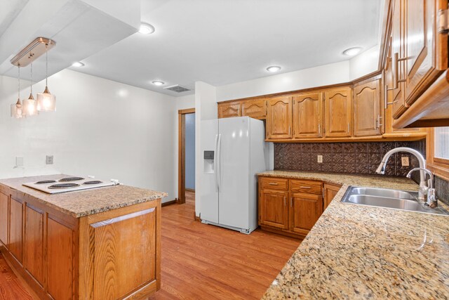 1007 Bryce Ln, Nixa, MO 65714 - kitchen featuring white appliances, a sink, light wood-style floors, and brown cabinets