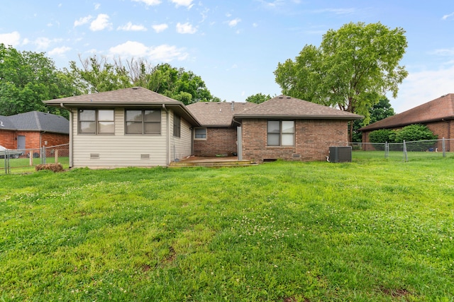 1007 Bryce Ln, Nixa, MO 65714 - back of property featuring central AC, brick siding, and a shingled roof
