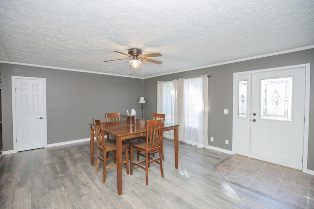 4857 S 101st Rd, Bolivar, MO 65613 - dining area featuring a ceiling fan, wood finished floors, a textured ceiling, crown molding, and baseboards