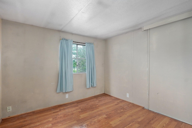 223 Harvest Dr, Rogersville, MO 65742 - spare room with wood finished floors and a textured ceiling