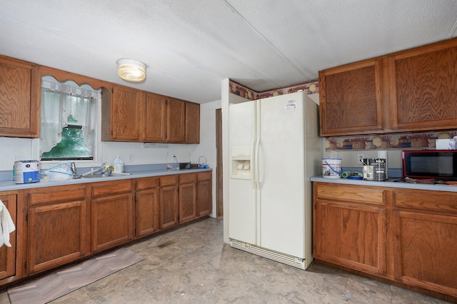 223 Harvest Dr, Rogersville, MO 65742 - kitchen featuring white refrigerator with ice dispenser, black microwave, brown cabinets, a sink, and light countertops