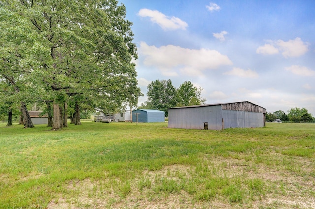 223 Harvest Dr, Rogersville, MO 65742 - view of grassy yard featuring an outbuilding and a carport