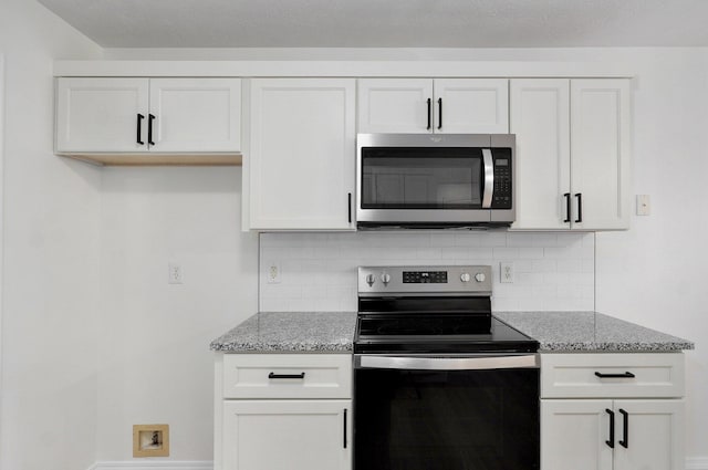 511 W Chestnut Rd, Nixa, MO 65714 - kitchen featuring stainless steel appliances, light stone counters, and decorative backsplash
