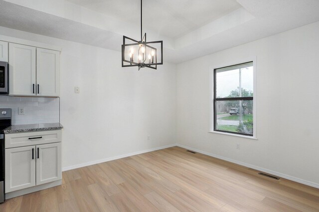 511 W Chestnut Rd, Nixa, MO 65714 - unfurnished dining area featuring light wood-type flooring, a chandelier, and baseboards