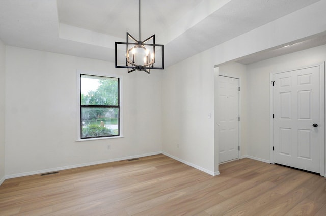 511 W Chestnut Rd, Nixa, MO 65714 - spare room with light wood-style flooring, a chandelier, and baseboards