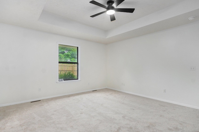 511 W Chestnut Rd, Nixa, MO 65714 - empty room with light colored carpet, a smoke detector, a ceiling fan, a tray ceiling, and baseboards