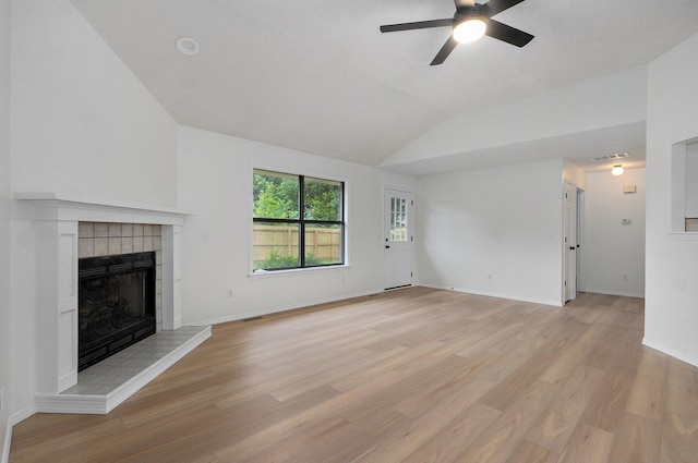511 W Chestnut Rd, Nixa, MO 65714 - unfurnished living room featuring vaulted ceiling, a ceiling fan, light wood-type flooring, a tiled fireplace, and baseboards