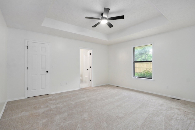511 W Chestnut Rd, Nixa, MO 65714 - carpeted empty room featuring a tray ceiling, a ceiling fan, and baseboards