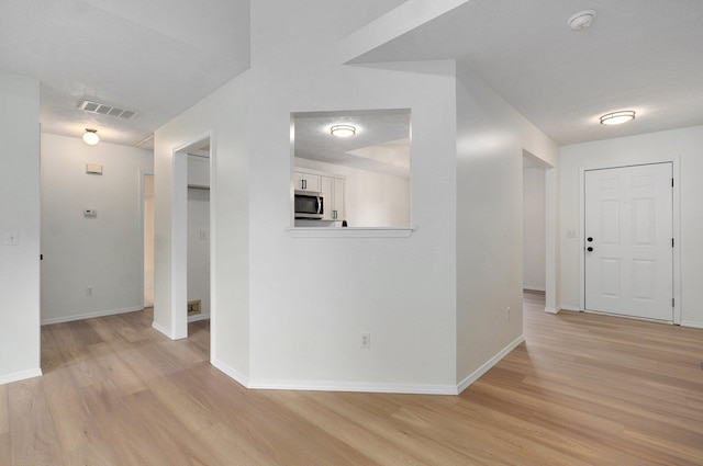 511 W Chestnut Rd, Nixa, MO 65714 - hallway with light wood finished floors and baseboards