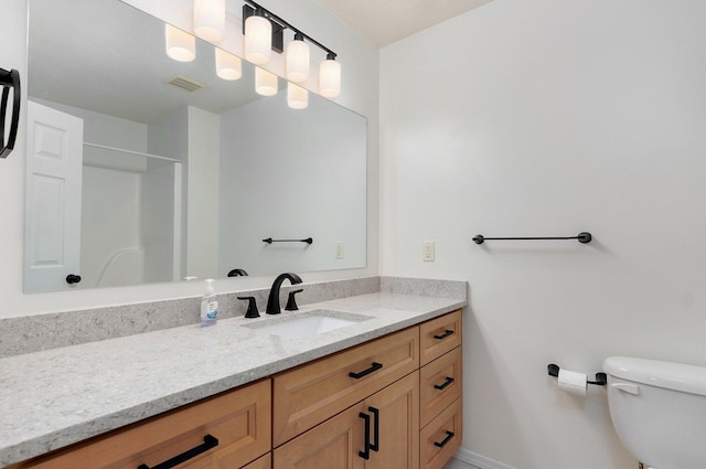 511 W Chestnut Rd, Nixa, MO 65714 - bathroom featuring vanity, toilet, a shower, and baseboards