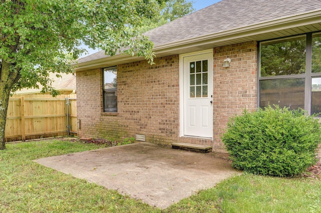 511 W Chestnut Rd, Nixa, MO 65714 - doorway to property with a shingled roof, a patio, and brick siding