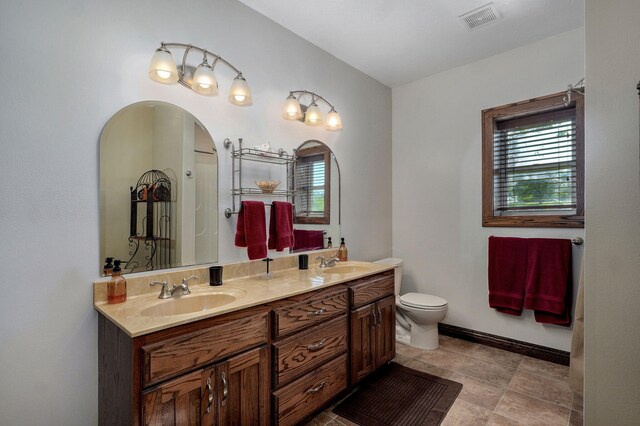 7519 W Farm Rd Unit 194, Republic, MO 65738 - bathroom featuring double vanity, toilet, and baseboards