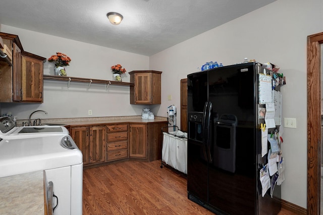 7519 W Farm Rd Unit 194, Republic, MO 65738 - kitchen with black fridge with ice dispenser, wood finished floors, open shelves, and a sink