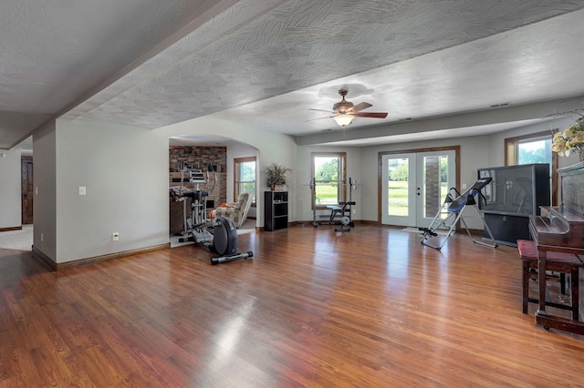 7519 W Farm Rd Unit 194, Republic, MO 65738 - living room featuring wood finished floors, ceiling fan, baseboards, and arched walkways