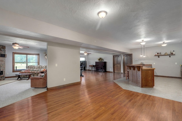 7519 W Farm Rd Unit 194, Republic, MO 65738 - living room featuring ceiling fan, wet bar, and baseboards
