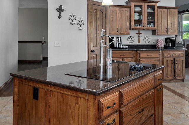 7519 W Farm Rd Unit 194, Republic, MO 65738 - kitchen featuring brown cabinetry, dark stone countertops, and glass insert cabinets