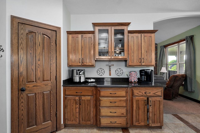 7519 W Farm Rd Unit 194, Republic, MO 65738 - kitchen featuring brown cabinets, glass insert cabinets, and dark stone countertops