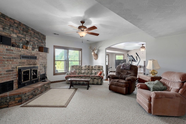 7519 W Farm Rd Unit 194, Republic, MO 65738 - living room with a ceiling fan, a fireplace, carpet floors, arched walkways, and baseboards
