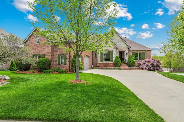 3912 E Windsmore Dr, Springfield, MO 65802 - view of front facade featuring driveway, brick siding, and a front yard