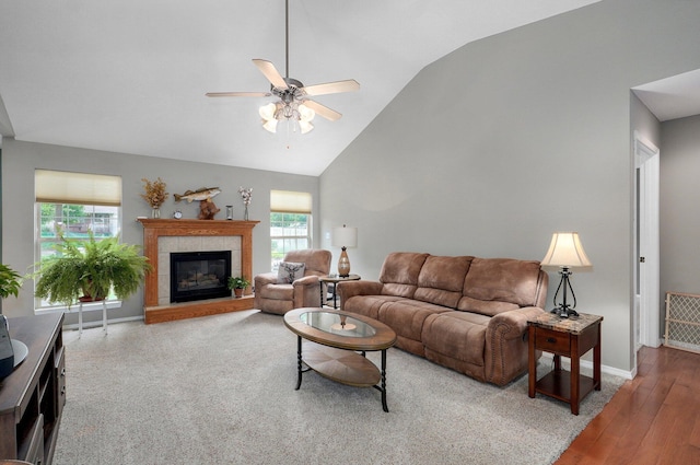 382 S Yellowwood Dr, Springfield, MO 65809 - living room with ceiling fan, vaulted ceiling, a tile fireplace, baseboards, and wood finished floors