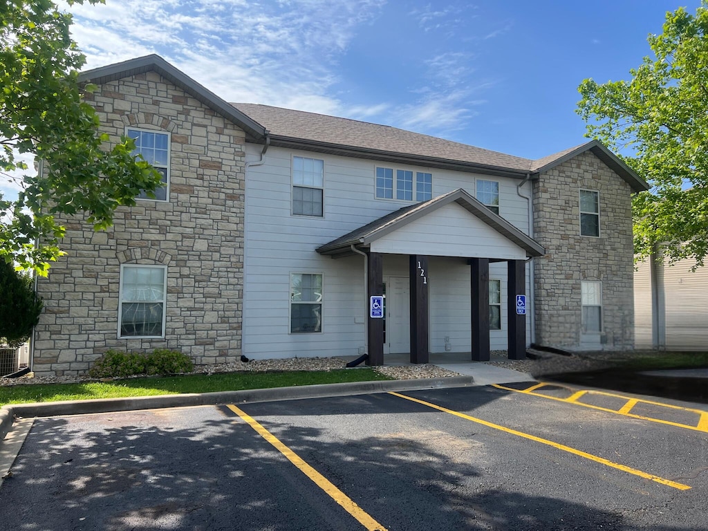 121 Toni Ln Unit 1-4, Branson, MO 65616 - view of front of house featuring stone siding and uncovered parking
