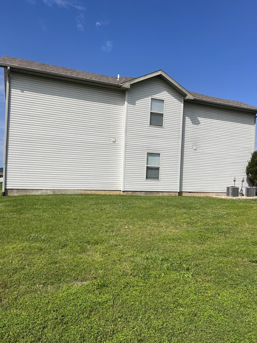 121 Toni Ln Unit 1-4, Branson, MO 65616 - view of side of home with a yard and central AC