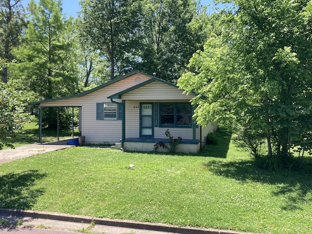 403 S W St, Mountain Grove, MO 65711 - bungalow-style house featuring concrete driveway, a front yard, an attached carport, and a porch
