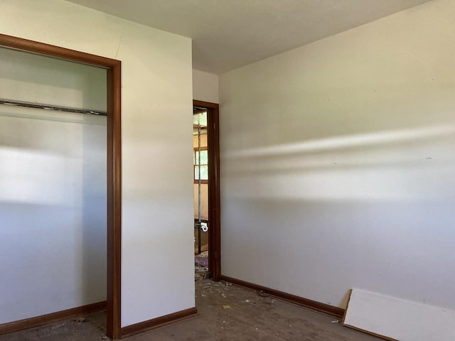 403 S W St, Mountain Grove, MO 65711 - unfurnished bedroom with baseboards, unfinished concrete floors, and a closet