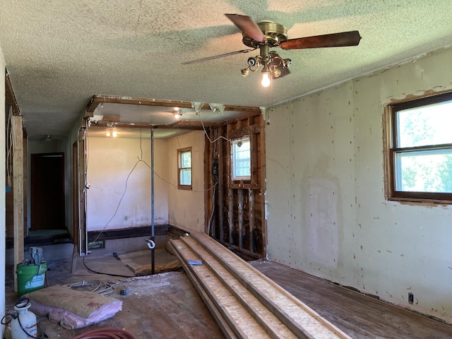 403 S W St, Mountain Grove, MO 65711 - unfurnished room with a textured ceiling, healthy amount of natural light, and a ceiling fan