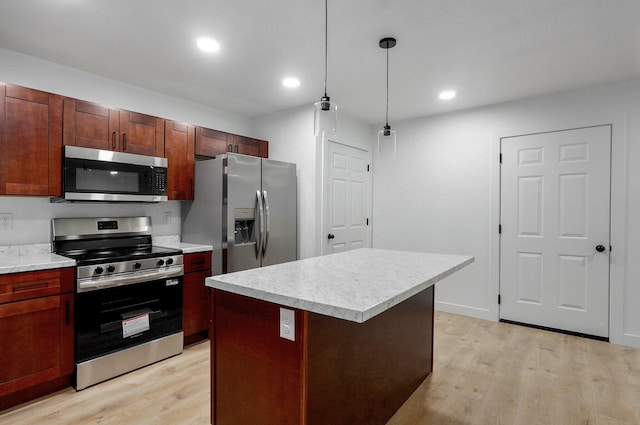 1620 N Texas Ave, Springfield, MO 65803 - kitchen featuring stainless steel appliances, light wood-style floors, light countertops, a kitchen island, and pendant lighting