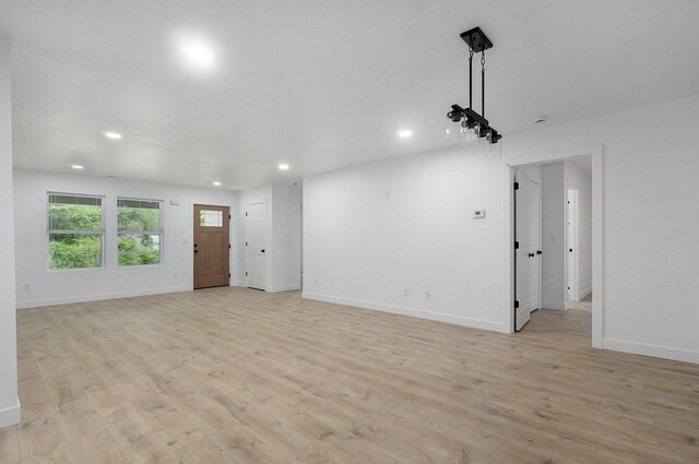 1620 N Texas Ave, Springfield, MO 65803 - unfurnished living room featuring recessed lighting, light wood-style floors, and baseboards